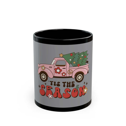 Black ceramic mug with pink vintage truck carrying Christmas tree and "Tis the Season" text design