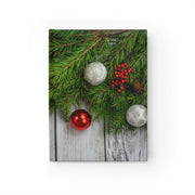 Canvas print with Christmas decorations including green branches, red berries, and silver and red ornaments on a wooden background.