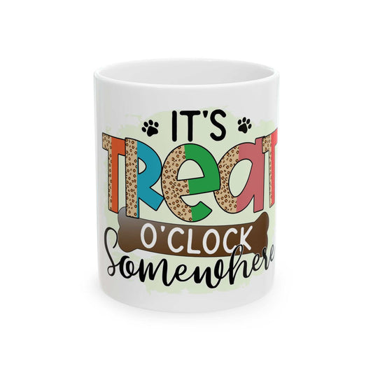 White ceramic mug with colorful "It's Treat O'clock Somewhere" text and paw prints design, 11oz size, dishwasher safe.