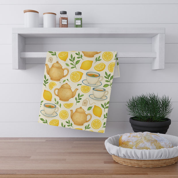 Tea towel with teapot and lemon design hanging on a kitchen wall.