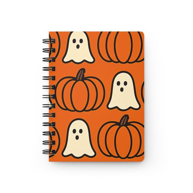 Notebook with Halloween design featuring pumpkins and ghosts on an orange background