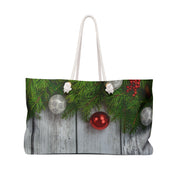 Christmas-themed tote bag with pine branches and ornaments on a white background